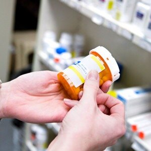 woman holding pill bottle