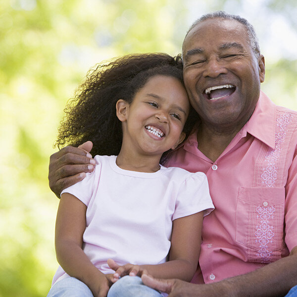 Grandfather laughing with granddaughter