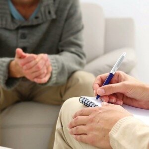 therapist with patient writing